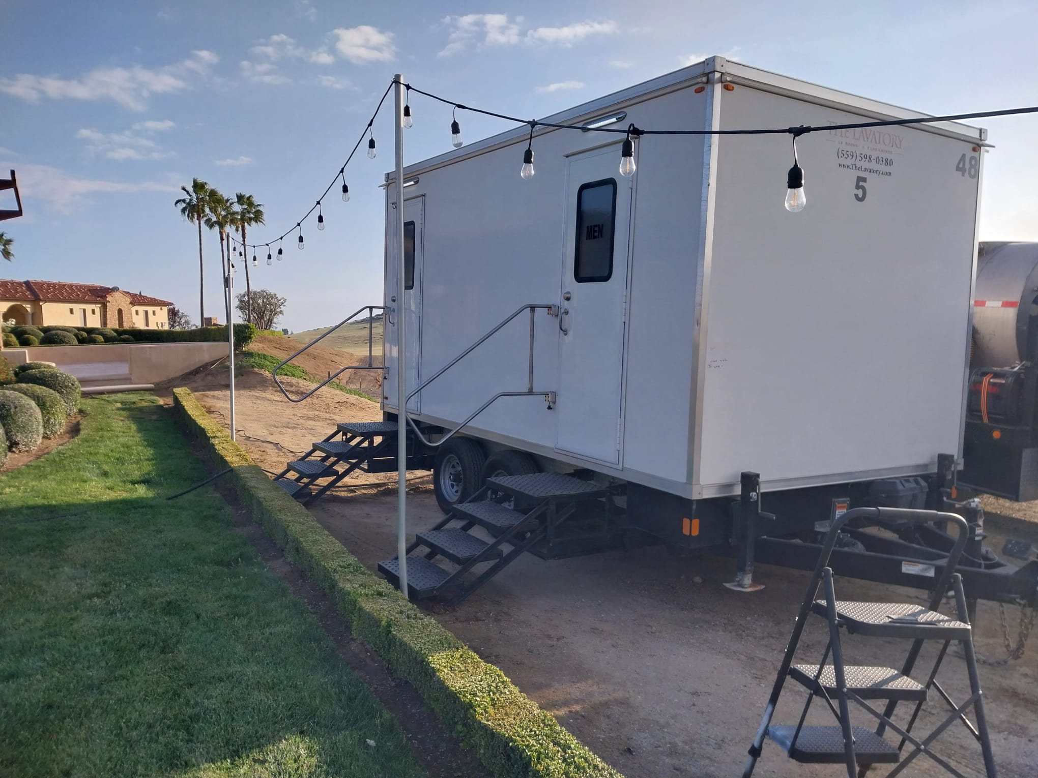 Denver wedding luxury restroom trailer rental. Elegant porcelain bathroom trailer at outdoor wedding venue